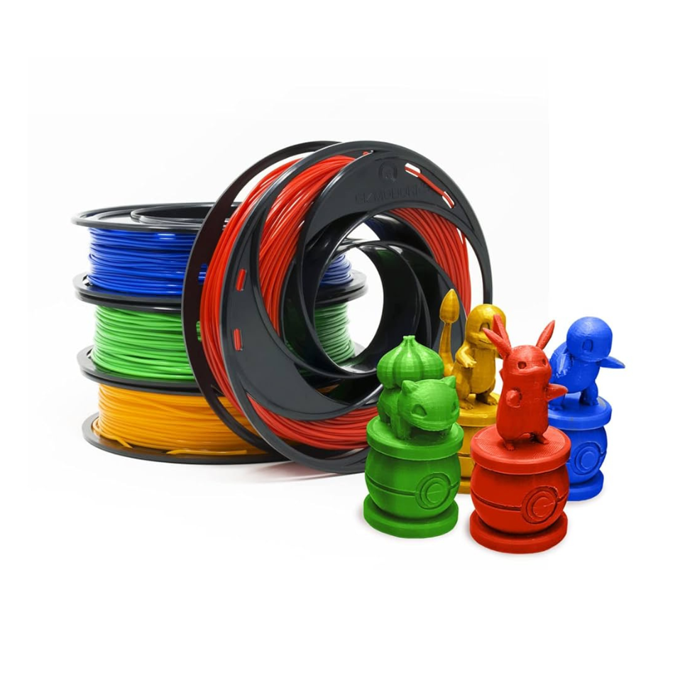 Rolls of red, blue, green, and yellow filament with 3D printed models of Pokemon made in the same colors.